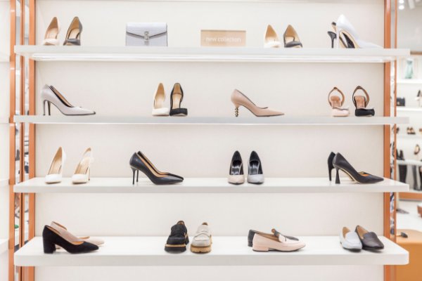 Wall featuring rows of high end women's shoes