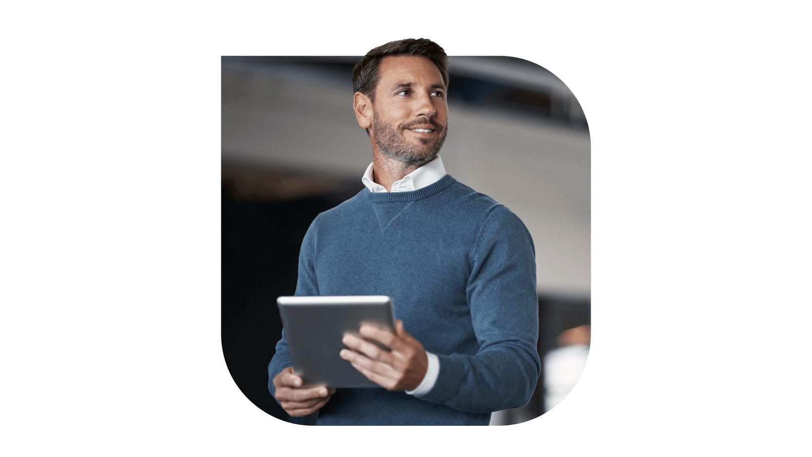 A gentleman gazing sideways holding a tablet