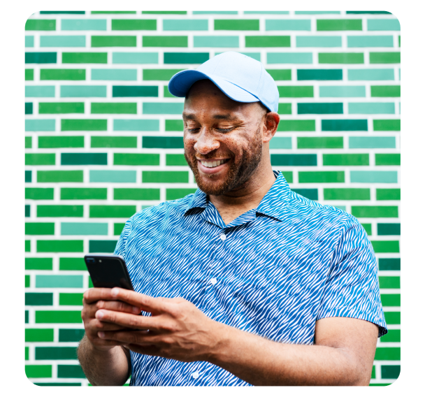 A happy man looking at phone screen