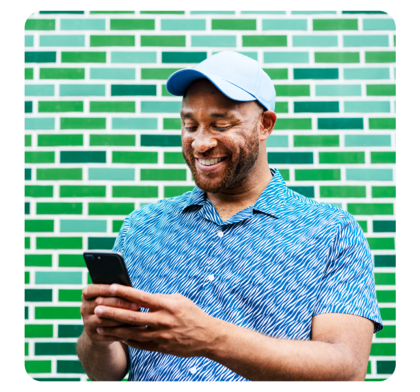 A happy man looking at phone screen