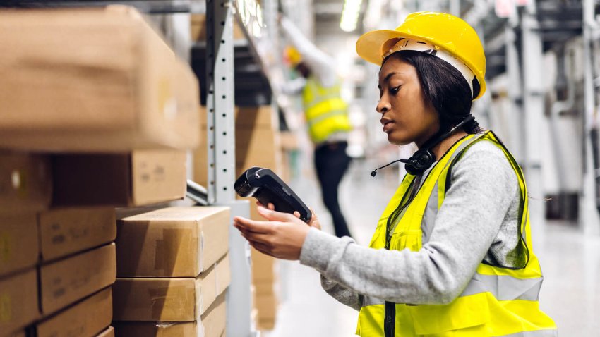 A warehouse worker scanning items through handheld device