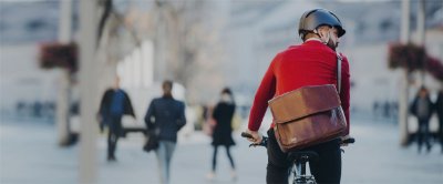 Man riding a bike down a busy city street