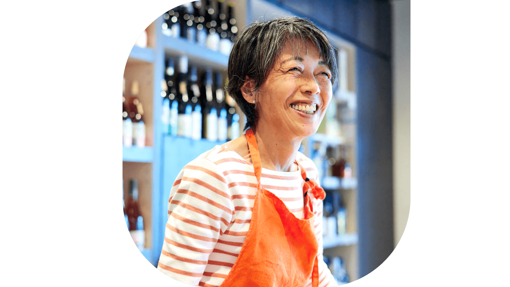A woman worker with a smile in a wine shop