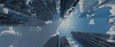 View looking up at the sky surrounded by tall skyscrapers on a cloudy day