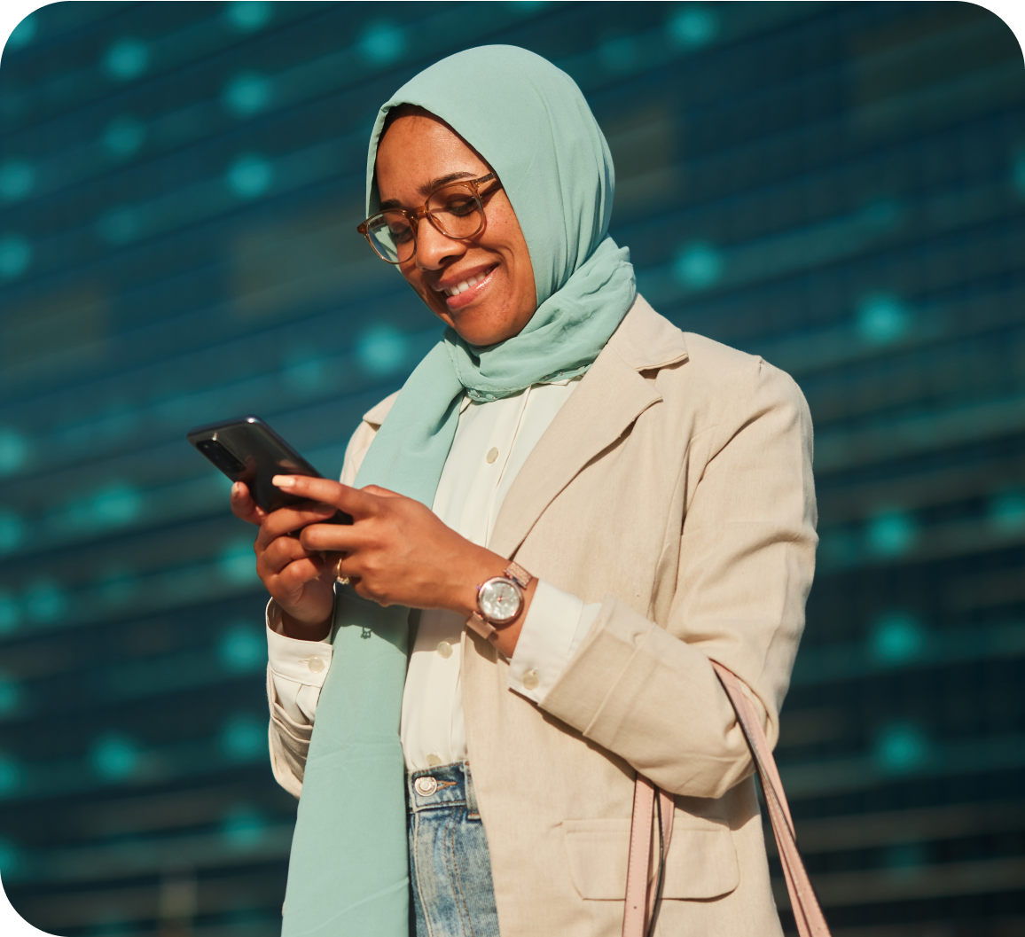 A woman looking at phone screen with a smile