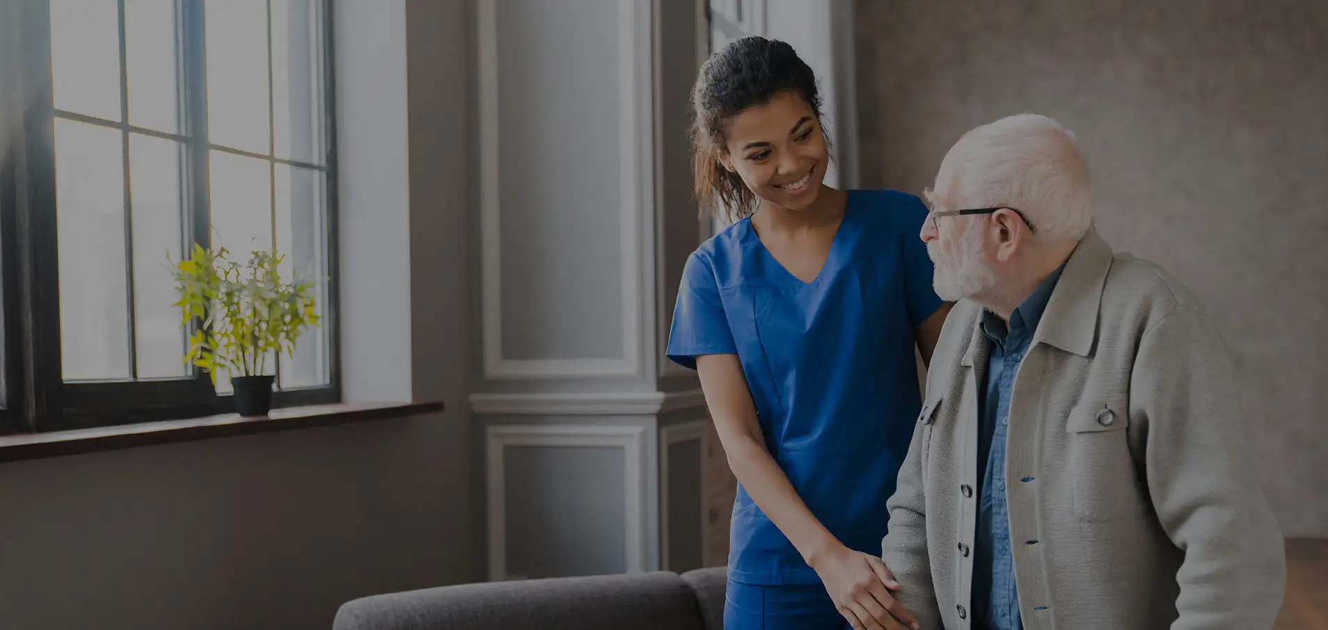 Healthcare worker helping an elderly patient