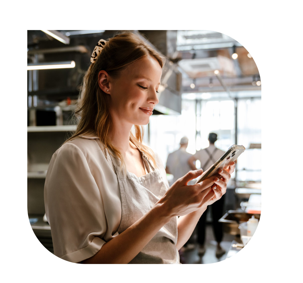 A woman looking at phone screen with a smile