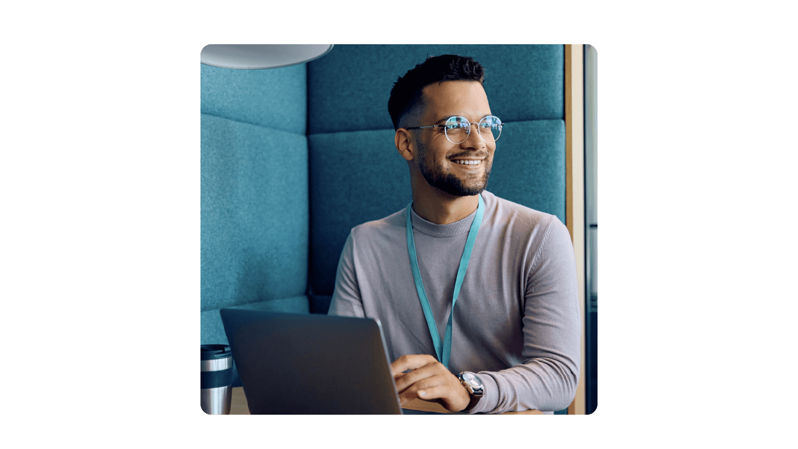 A man working on a laptop with a smile on his face