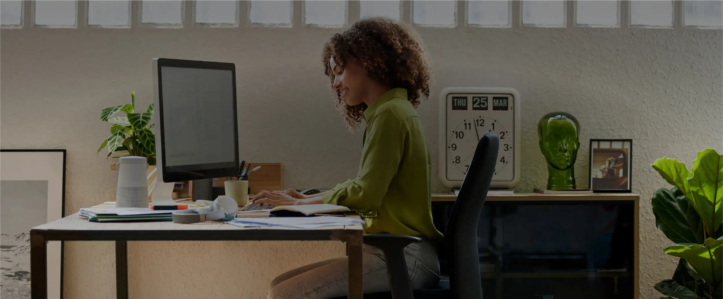 Woman working on a computer in a home office