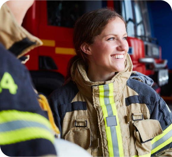 A firefighter woman with a smile on her face