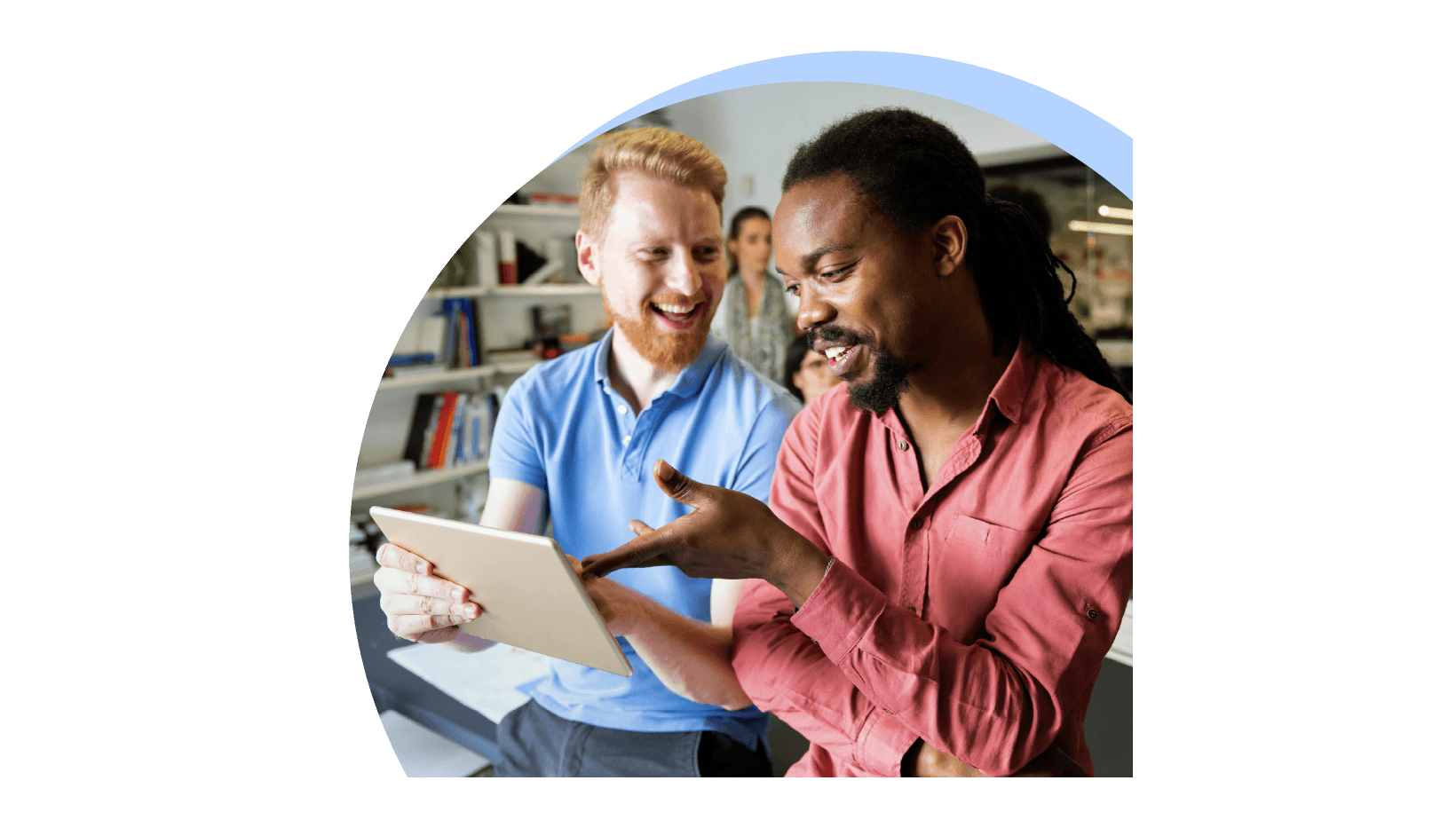 Two office employees in a discussion while looking at tablet screen