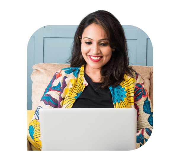 A woman working on laptop with the smile on her face