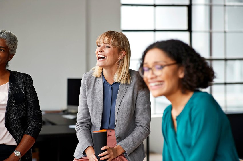 A group of happy women in a discussion at work