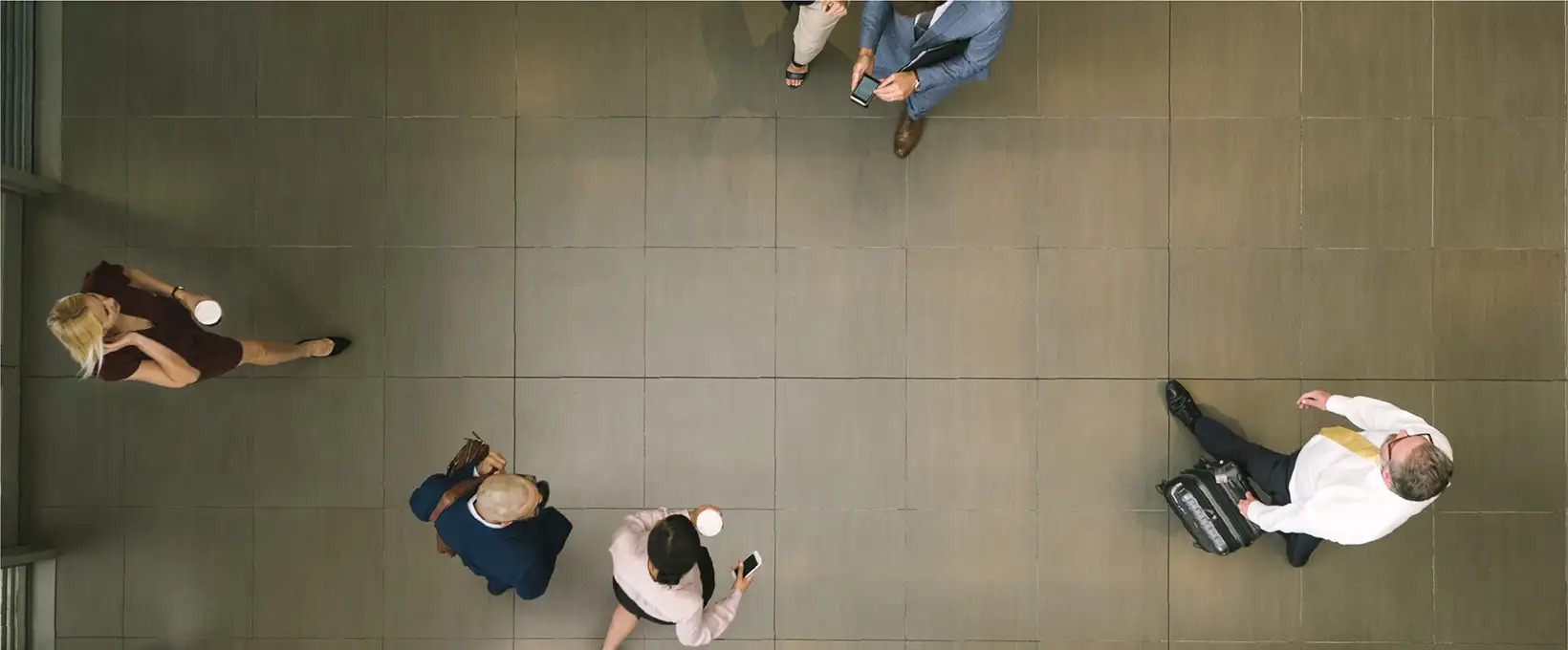 A look down at business people walking through a lobby