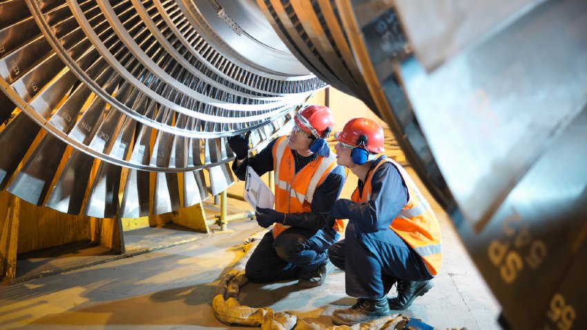 Engineers inspecting turbine blades